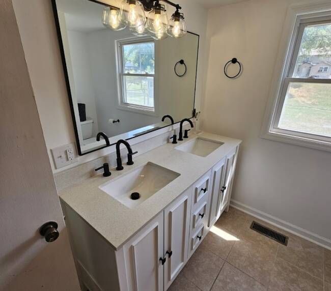 Example of home additions featuring updated bathroom after being renovated by Top Quality Builders