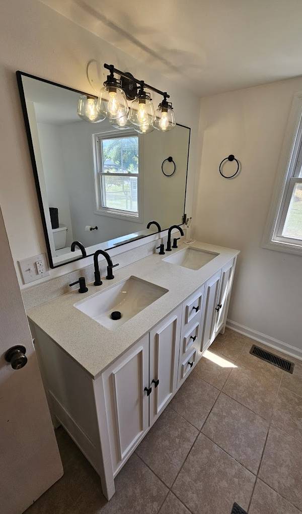 Example of home additions featuring updated bathroom after being renovated by Top Quality Builders