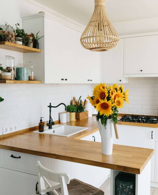 modern kitchen with white cabinets wood countertop